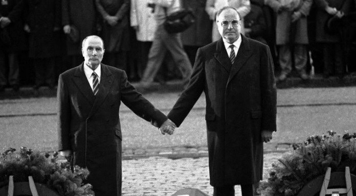 Photo du président François Mitterrand et du Chancelier allemand Helmut Kohl se tenant la main lors de la cérémonie de 1984 en l'hommage de victimes de Verdun.